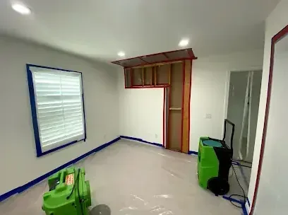 Drying equipment running in a room partway through a water damage dry-out